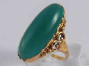 Appraisal: A yellow metal tests carat gold green stone ring approx