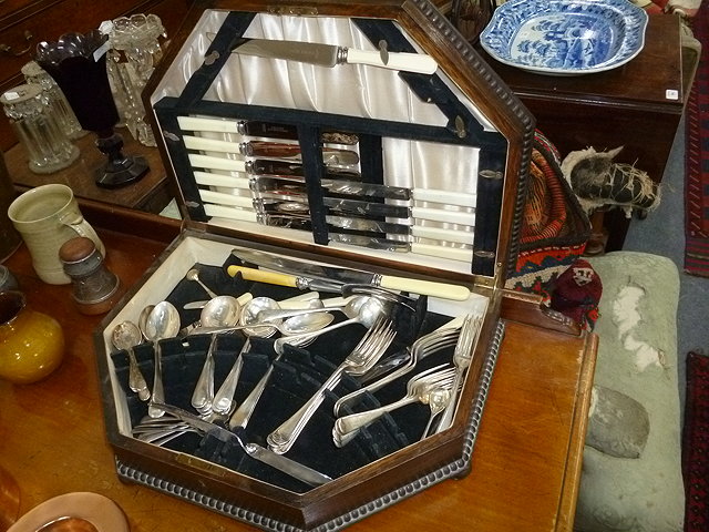 Appraisal: A PART CANTEEN OF SILVER PLATED CUTLERY in an oak