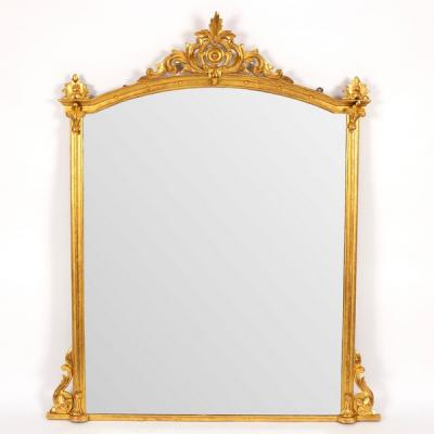 Appraisal: An arch-top gilded overmantel mirror with moulded border the plate