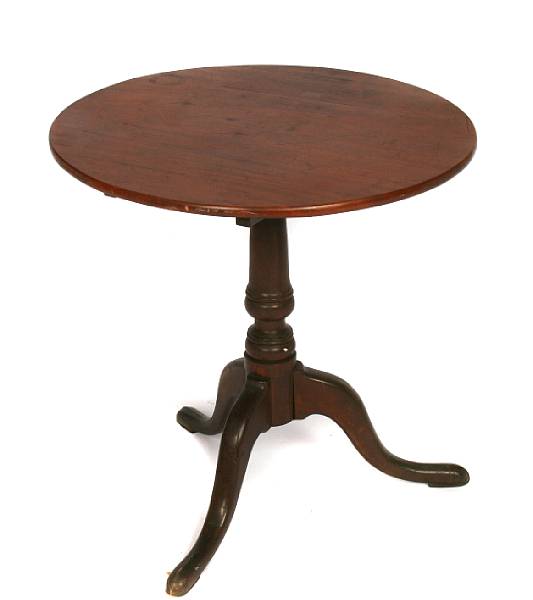 Appraisal: A George III fruitwood circular tilt top occasional table height