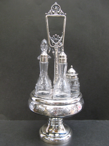 Appraisal: VICTORIAN SILVERPLATED CASTER STAND -bottle with engraved glass design including