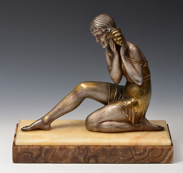 Appraisal: An Art Deco spelter figure of a seated girl holding