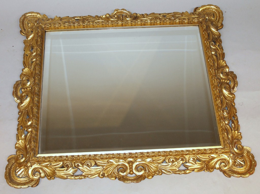 Appraisal: An thC style rococo design giltwood wall mirror with plain