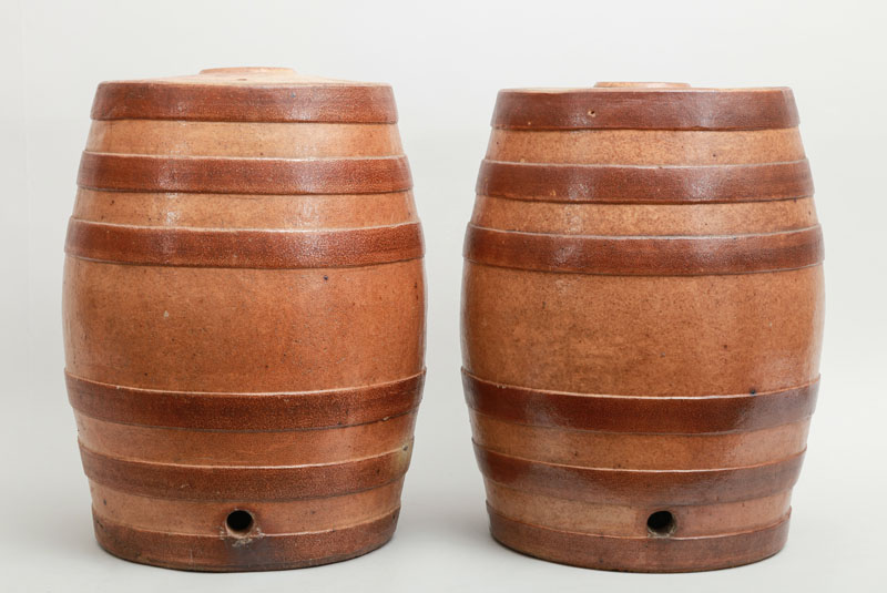 Appraisal: PAIR OF ENGLISH BROWN-GLAZED STONEWARE BARREL-FORM DISPENSERS Lacking fittings x