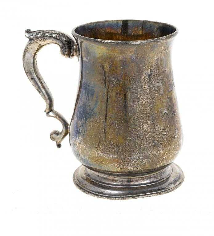 Appraisal: A GEORGE II MUG of baluster shape with leaf capped