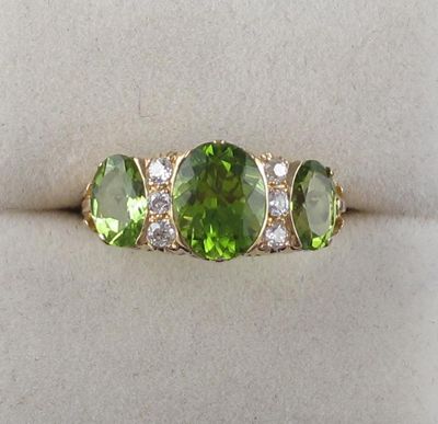 Appraisal: A three stone peridot half hoop ring Set in gold