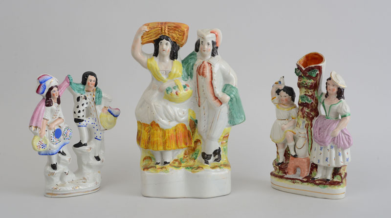 Appraisal: SIX STAFFORDSHIRE POTTERY FIGURE GROUPS Comprising a pair of youth