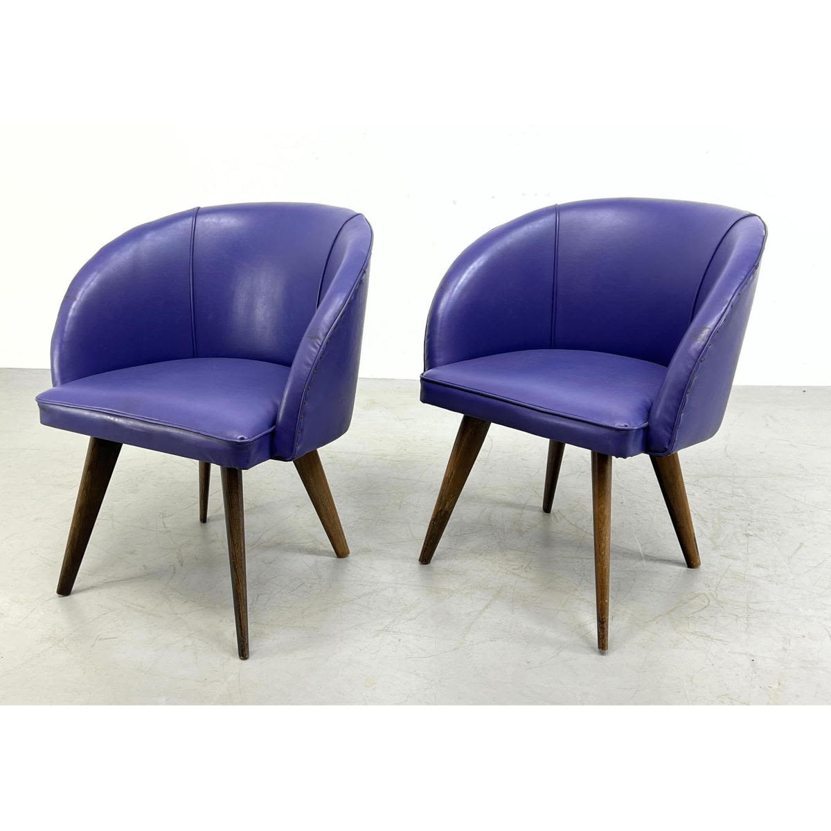 Appraisal: Pr vintage vinyl purple barrel chairs Studded around back Tapered