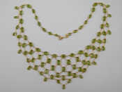 Appraisal: A yellow metal tests carat gold peridot fringe necklace approx