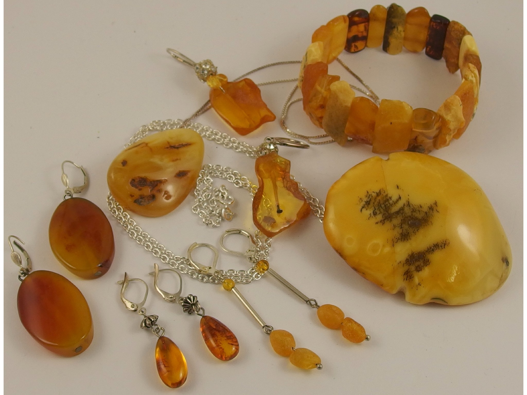 Appraisal: A large amber coloured bead statement pendant and other amber