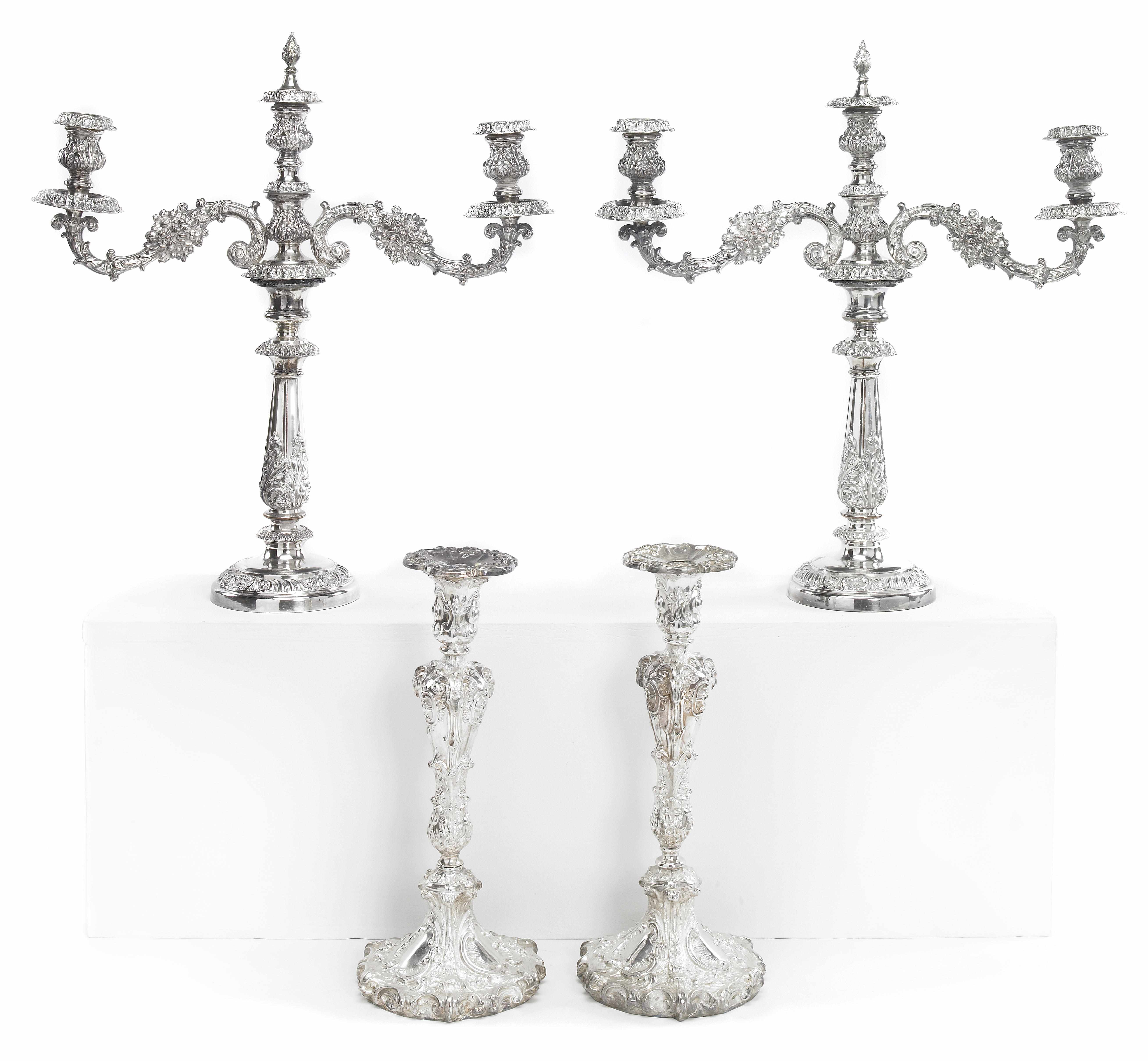 Appraisal: A set of four antique plated candlesticks Damaged together with