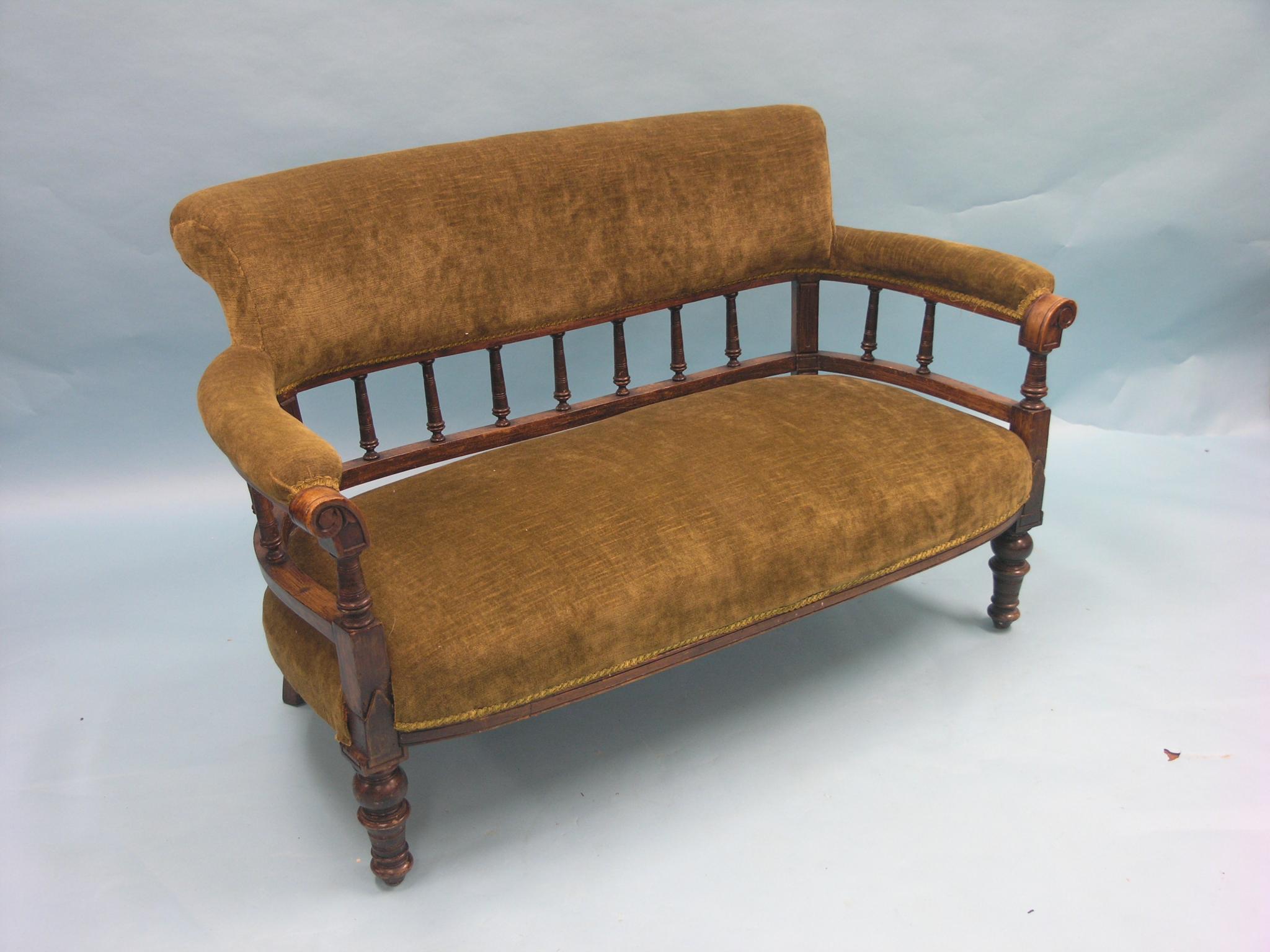 Appraisal: A Victorian walnut-framed two-seater settee turned spindles and front turned