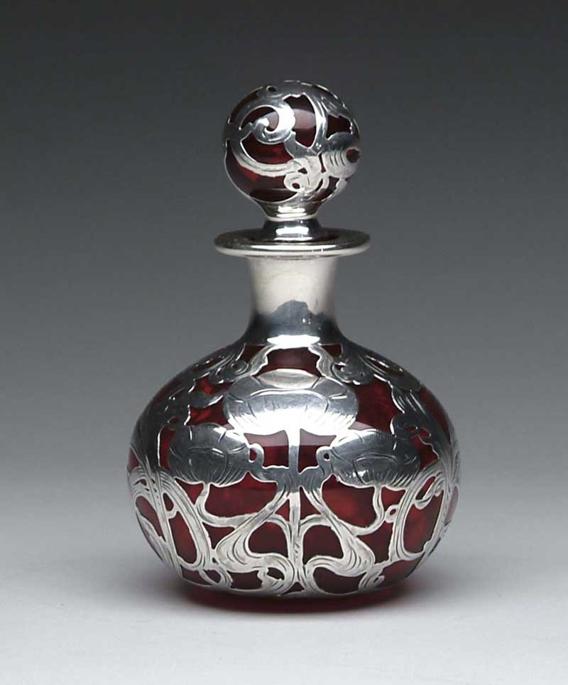 Appraisal: RARE CRANBERRY SILVER OVERLAY PERFUME BOTTLE Globular shape with matching