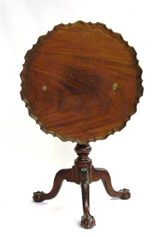 Appraisal: Mahogany pie crust tea table turned standard feather carved ball