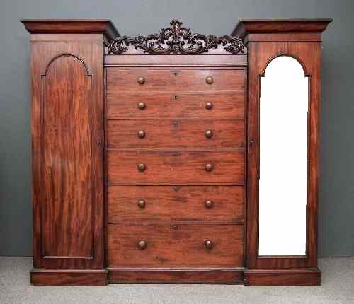 Appraisal: An early Victorian figured mahogany wardrobe the drop centre with