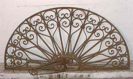 Appraisal: A Wrought Iron Arched Transom Grill with Lantern Bracket having