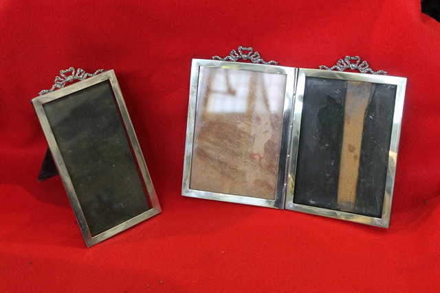 Appraisal: A FOLDING SILVER PHOTO FRAME of plain form with ribbon