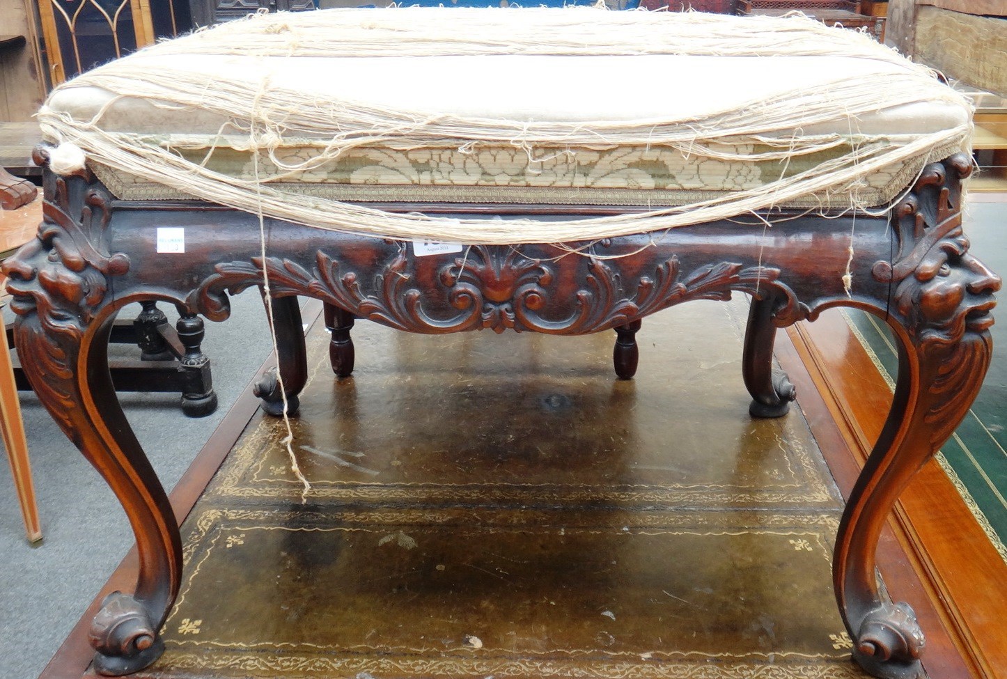 Appraisal: An th century style carved mahogany rectangular foot stool on