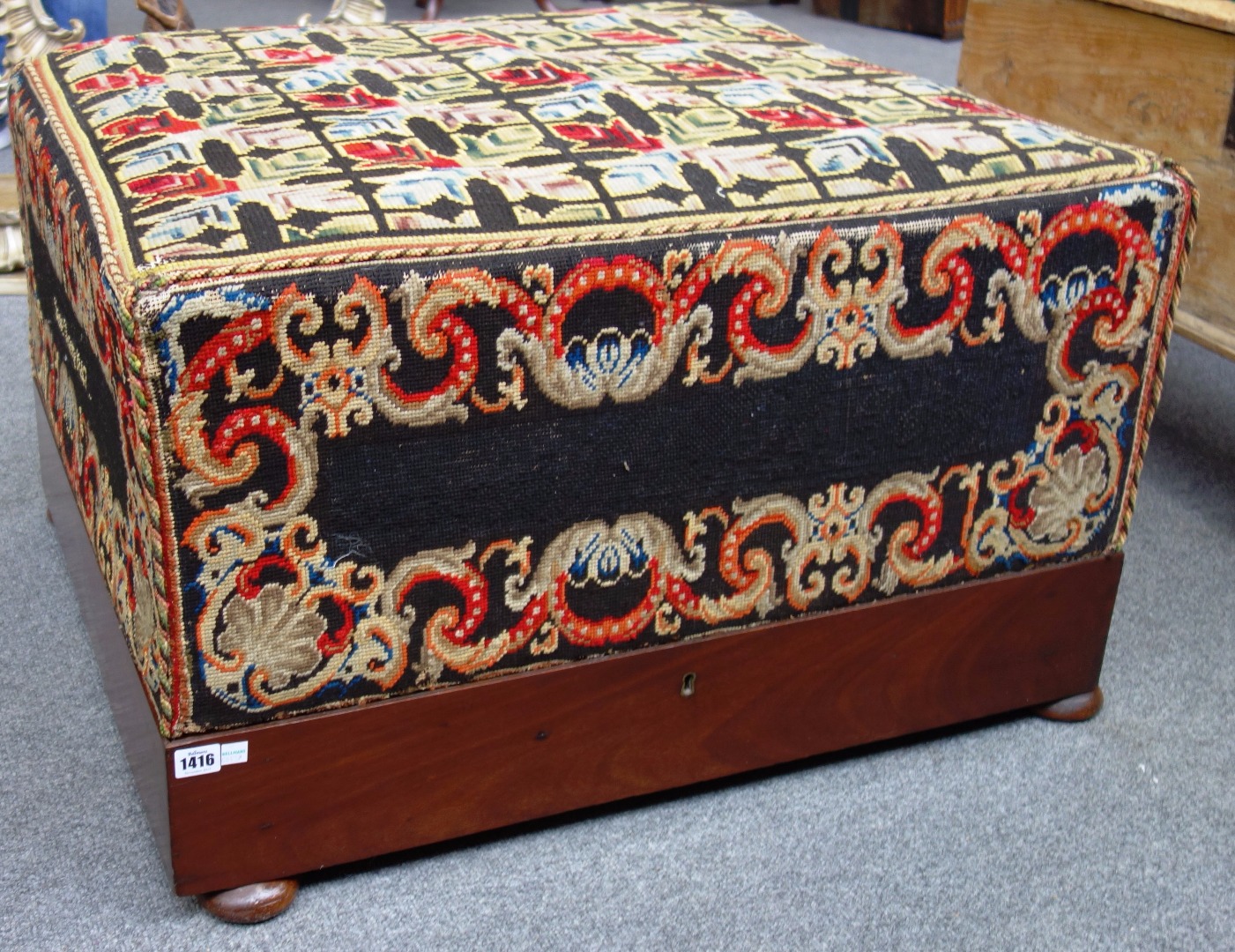 Appraisal: An early Victorian mahogany framed box ottoman with tapering upholstered