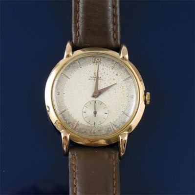 Appraisal: A gentleman's gold wristwatch by Omega Plain dial with subsidiary