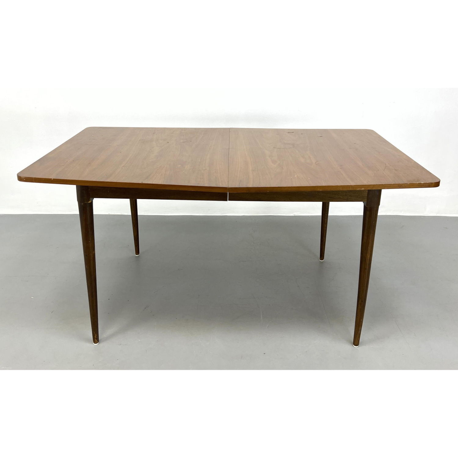 Appraisal: American Modern Walnut Dining table Tapered legs No leaves Dimensions