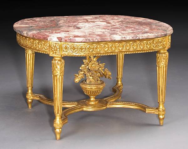 Appraisal: A Louis XVI style carved giltwood center table The oval