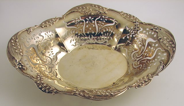 Appraisal: Serpentine oval form with pierced floral panels X retailed by