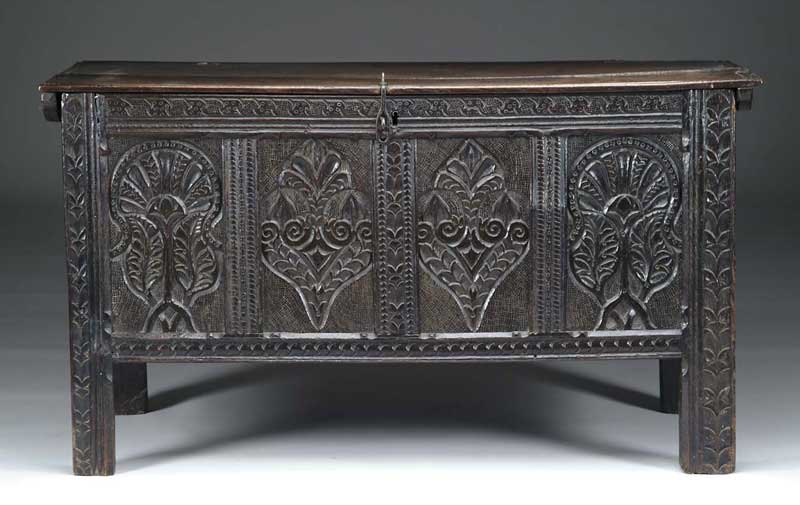 Appraisal: OUTSTANDING CARVED OAK COFFER The hinged plank top with molded