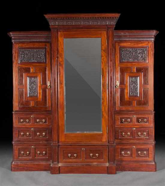 Appraisal: Edwardian carved mahogany wardrobe early th century classical carved dentil