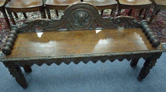 Appraisal: A Victorian oak carved bench the scrolling back with central