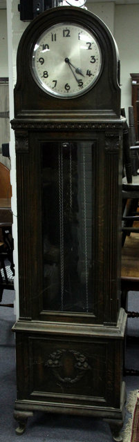 Appraisal: An oak longcase clock with arch top hood the trunk