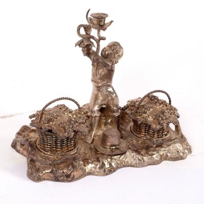 Appraisal: A novelty plated inkstand modelled as a boy holding a