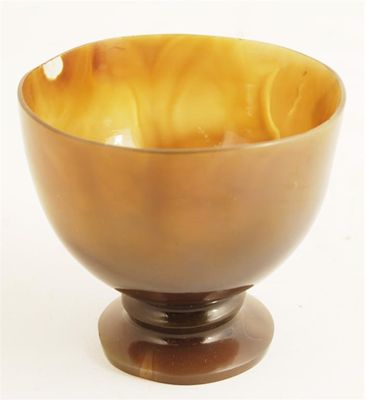 Appraisal: A turned agate cup raised on a flared foot and