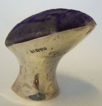 Appraisal: A silver mounted pin cushion shaped as a lace makers