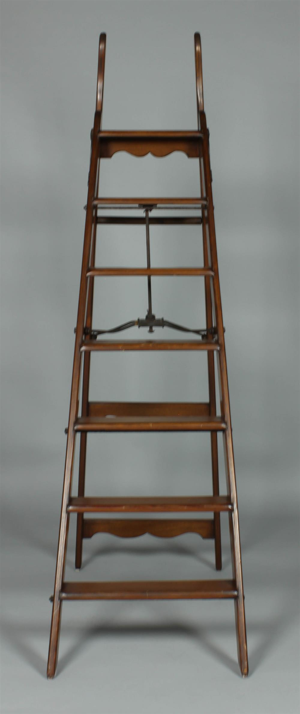 Appraisal: EDWARDIAN FOLDING MAHOGANY SIMPLEX LADDER LIBRARY LADDER having shaped upper