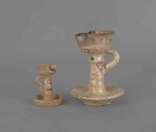 Appraisal: Two earthenware fat lamps ca h and h Provenance Titus