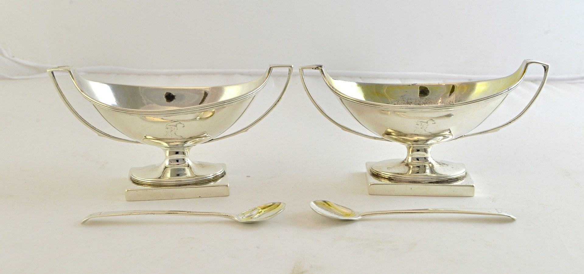 Appraisal: A pair of silver twin handled salts each of boat