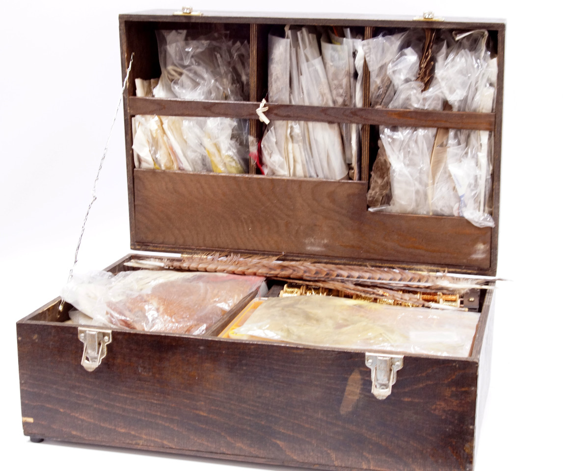 Appraisal: A collection of fly dressing materials contained in a wooden