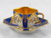 Appraisal: An Art Deco cup and saucer with blue panels heavily