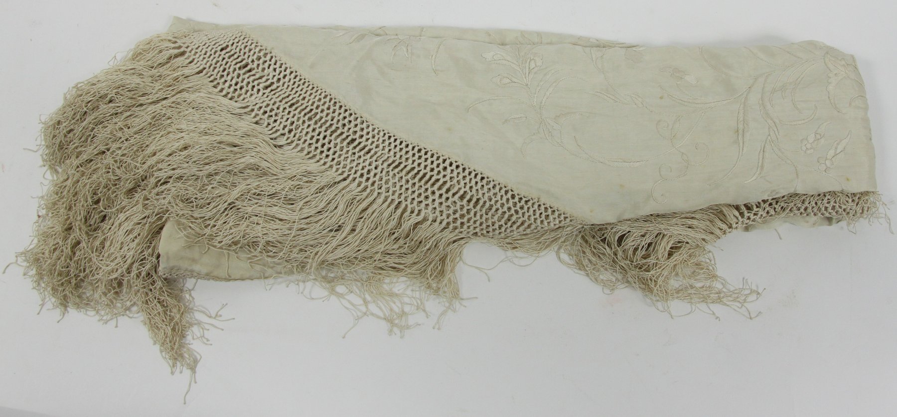 Appraisal: A Chinese cream silk shawl with floral embroidery trellis border