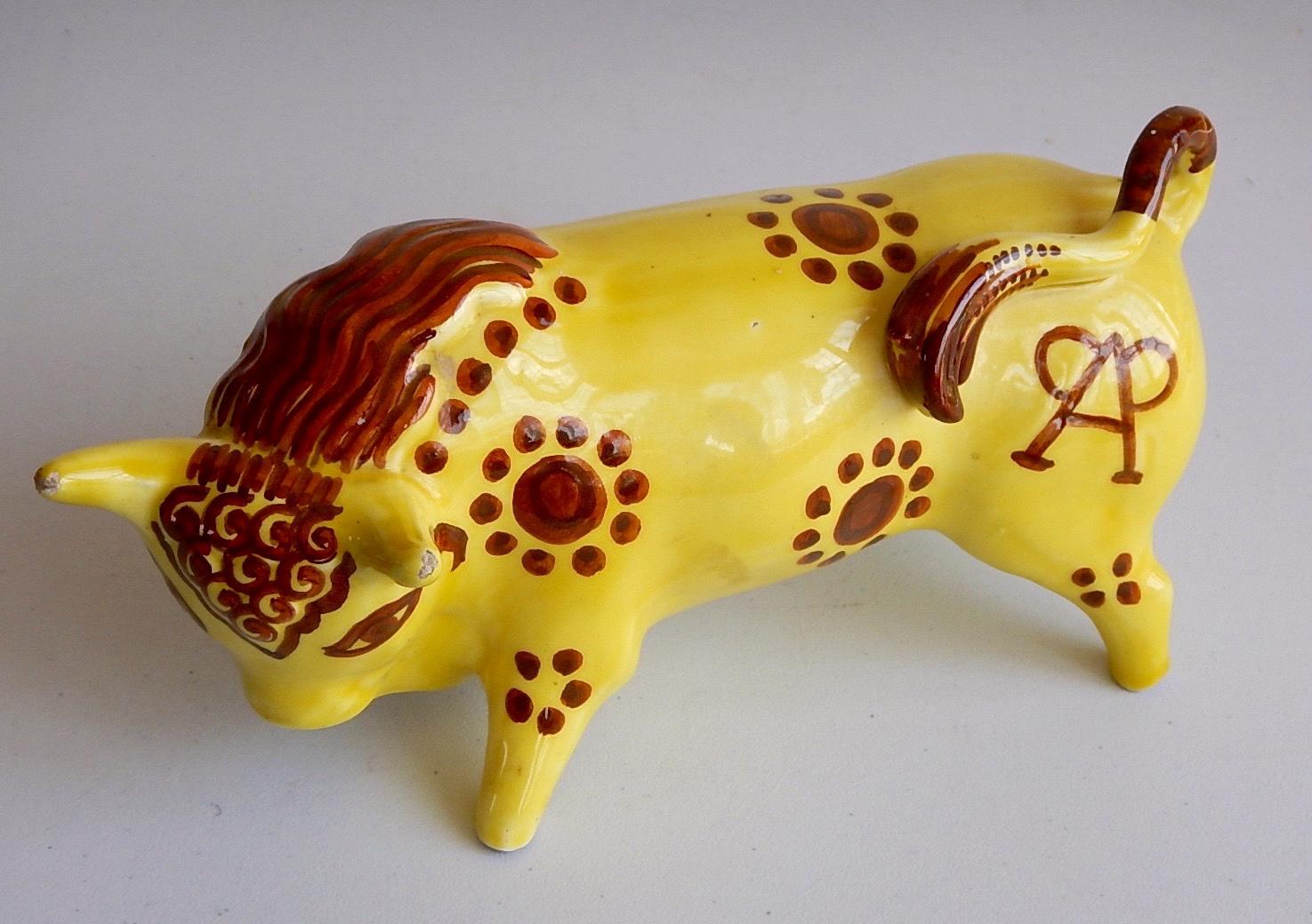 Appraisal: A pottery model of a bull in a yellow glaze