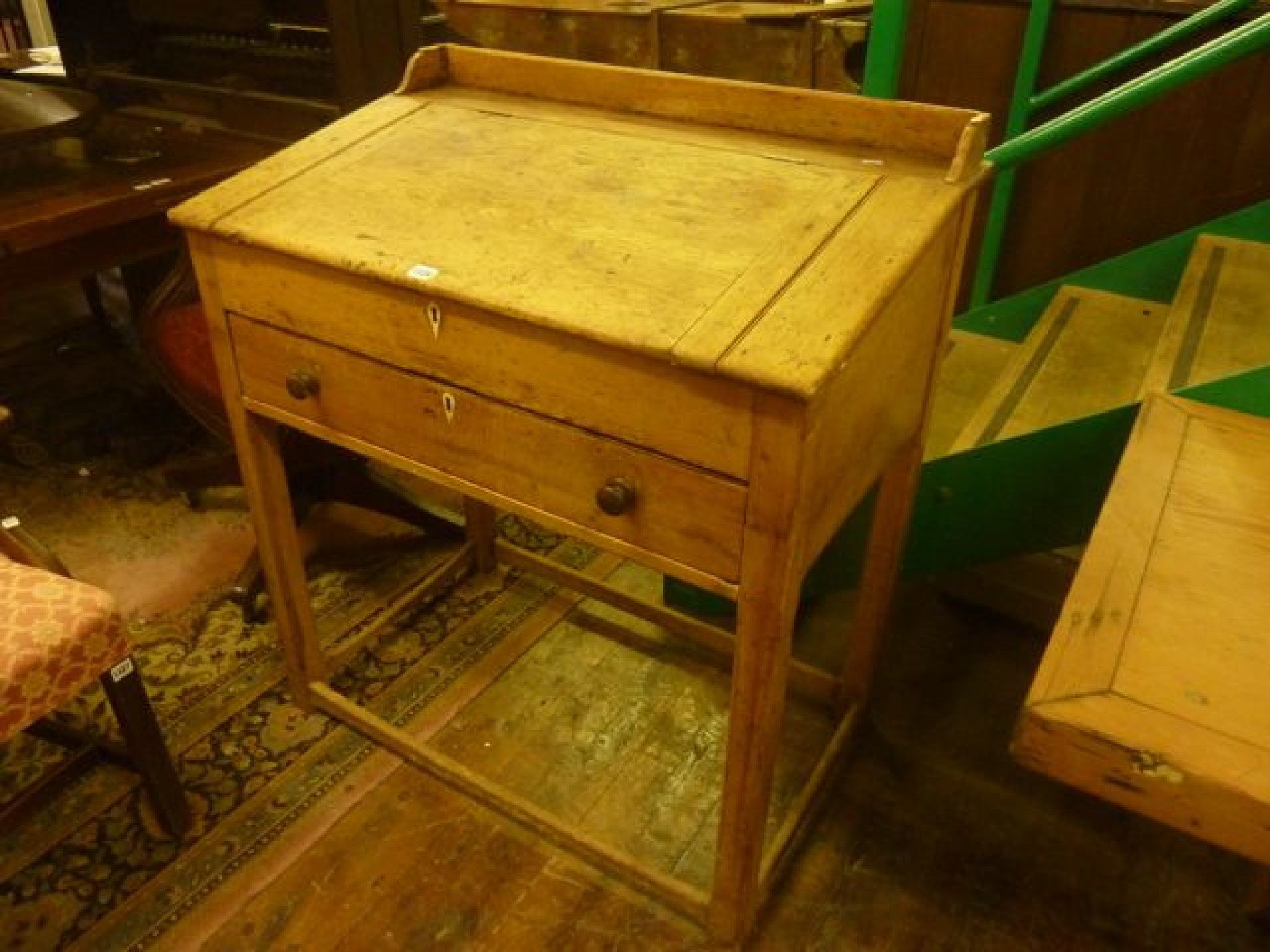 Appraisal: A th century stripped pine clerk's desk with shallow raised