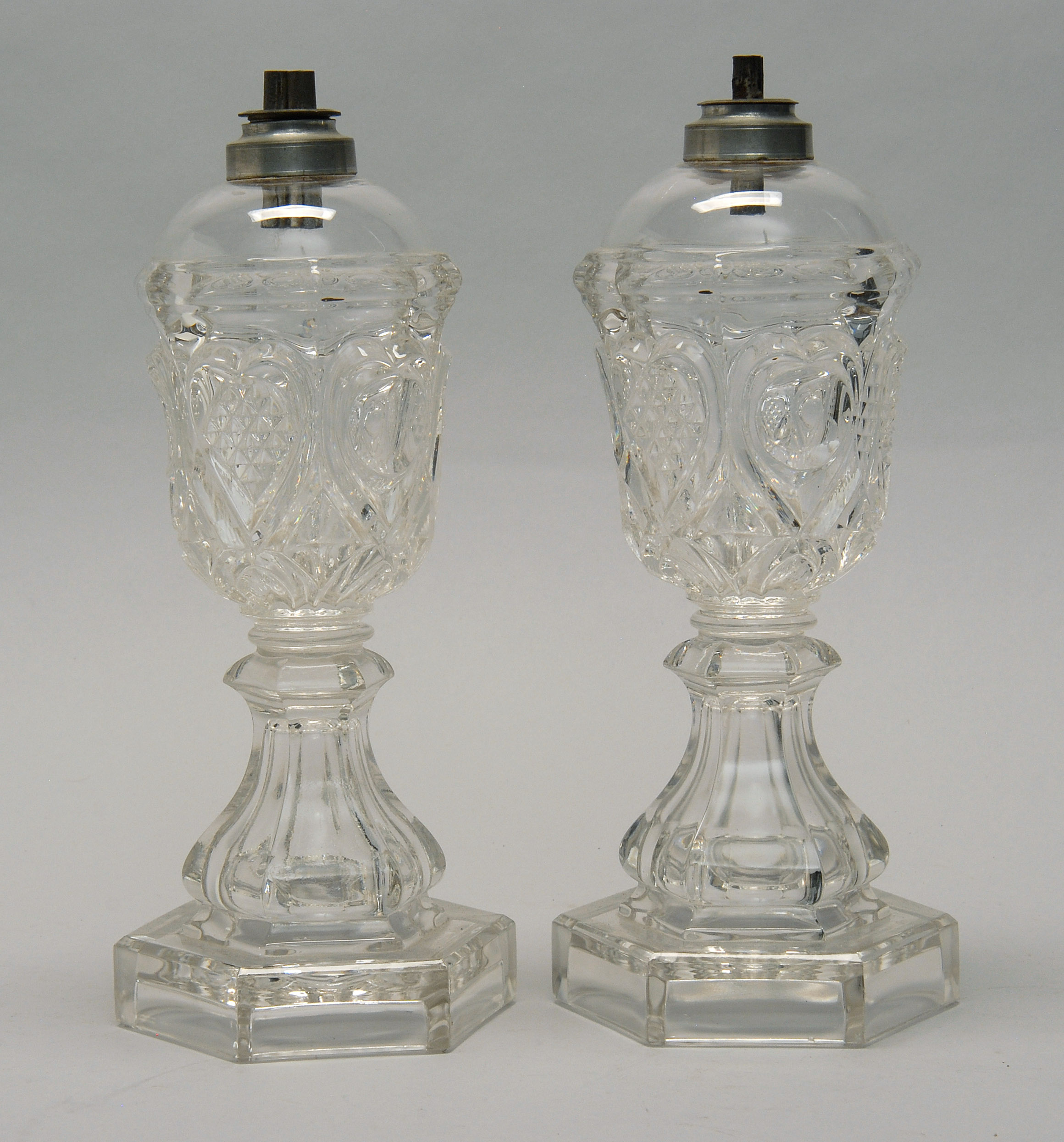 Appraisal: PAIR OF CLEAR SANDWICH GLASS WHALE OIL LAMPS Mid- th