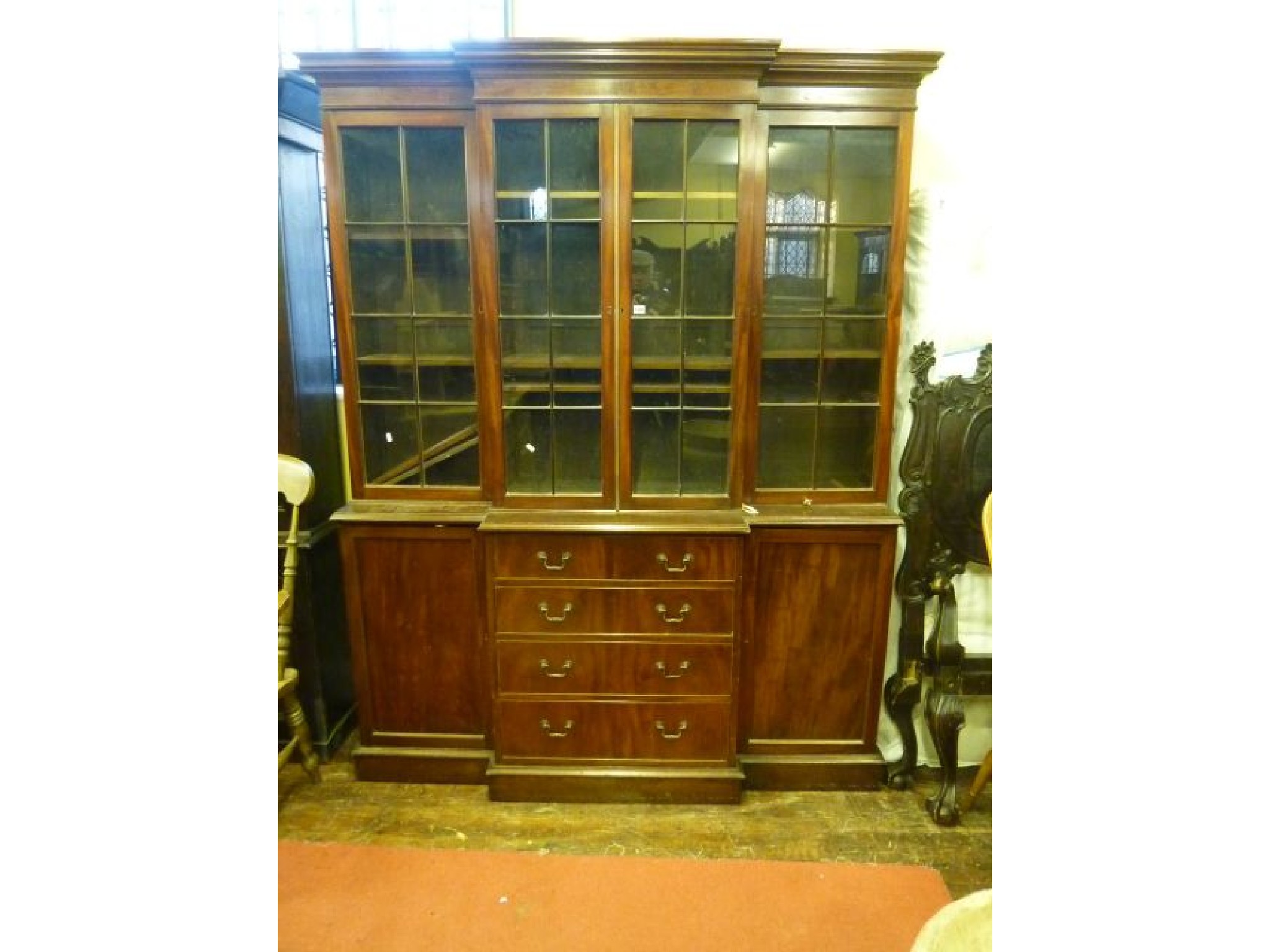 Appraisal: A good quality Georgian style mahogany breakfront library bookcase the