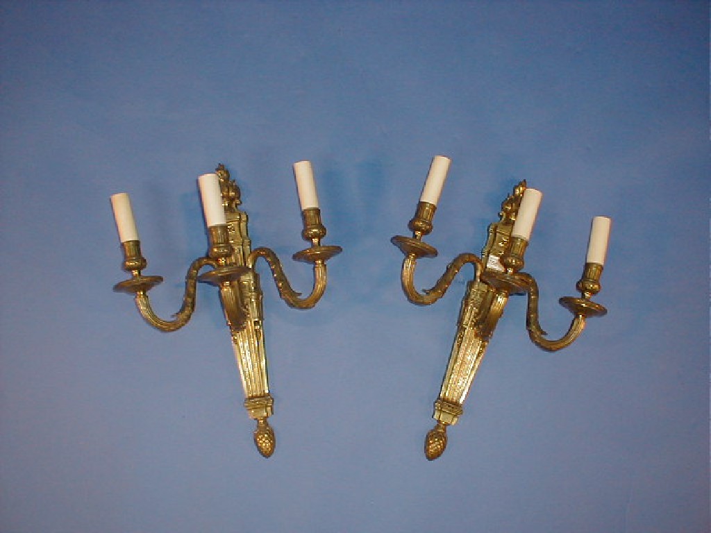 Appraisal: A pair of Louis XVI style gilt brass three light