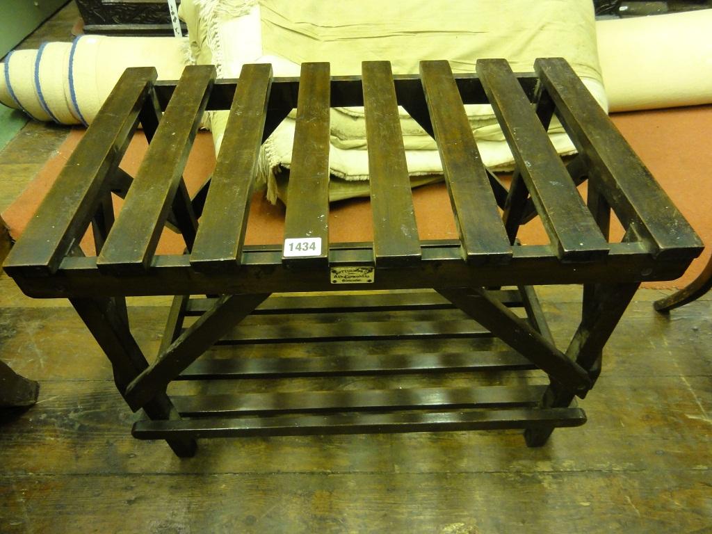 Appraisal: A walnut luggage stand with slatted frame adorning a rectangular