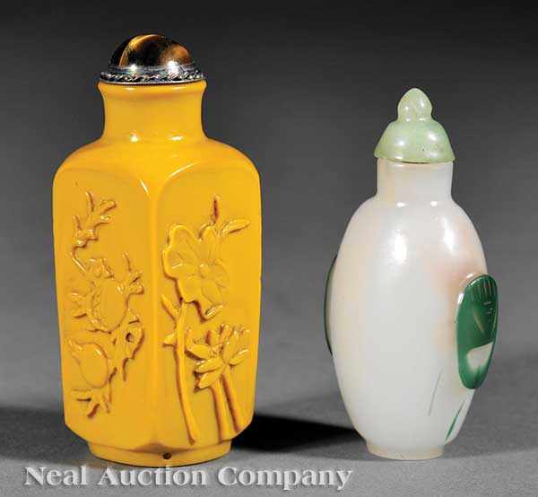 Appraisal: Two Chinese Carved Glass Snuff Bottles the first yellow glass