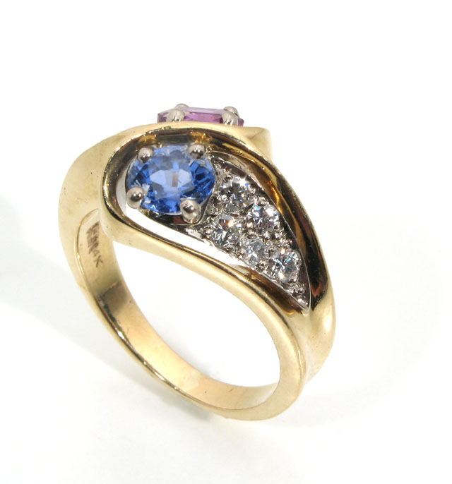 Appraisal: RUBY SAPPHIRE DIAMOND AND FOURTEEN KARAT GOLD the crossover style