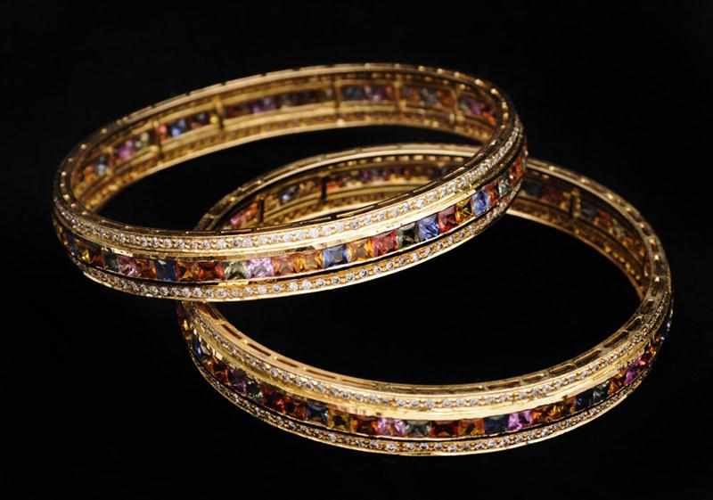 Appraisal: PAIR OF K GOLD MULTI COLORED SAPPHIRE AND DIAMOND BANGLE