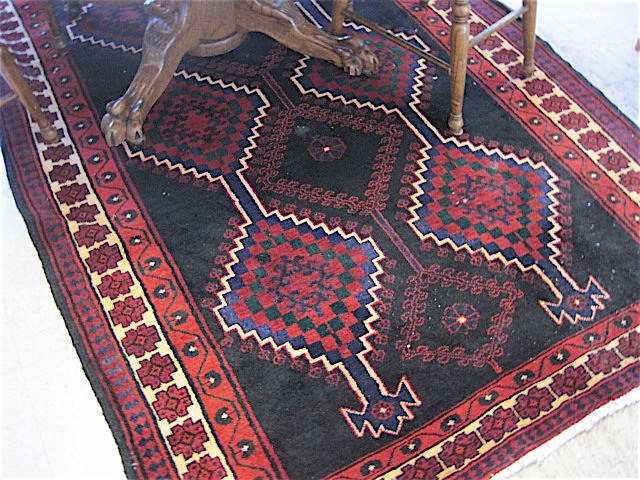 Appraisal: PERSIAN ILATI TRIBAL CARPET the black field decorated with three